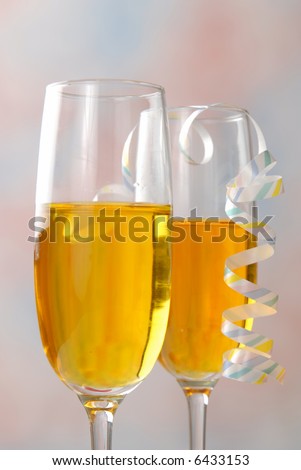 Two glasses of golden wine with party ribbon on a glass