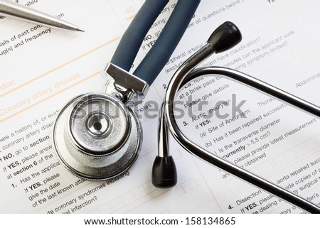 Medical form, stethoscope and pen