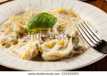 Italian tortellini in cream sauce with basil and parmesan cheese