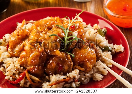 Fried chicken pieces with rice and sweet and sour sauce