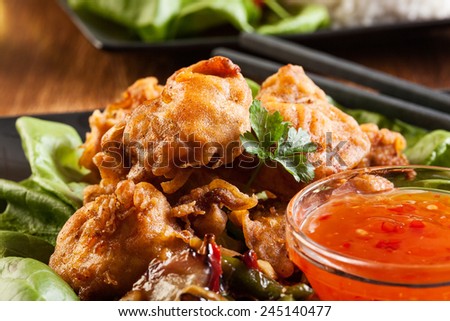 Fried chicken pieces in batter on a plate