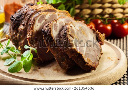 Roasted pork neck with spices on cutting board