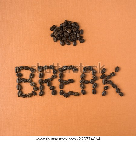 coffee break spelled out in beans with a pile of roasted beans