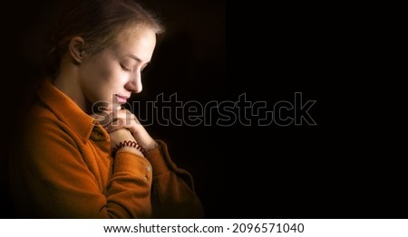 Dramatic evangelical pentecostal pious mourn pretty young light white lady kneeling ask implore wish upwards Jesus Christ. Vintage think life concept copyspace with space for text on dark backdrop Imagine de stoc © 