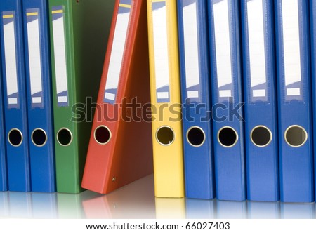 color ring binders in row isolated on white and reflection