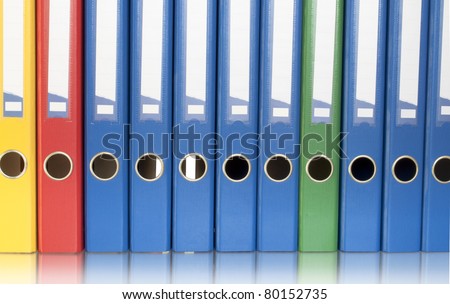 color ring binders in row isolated on white and reflection