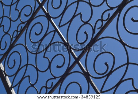 Curly details of the Iron Gate with blue sky in bacground.