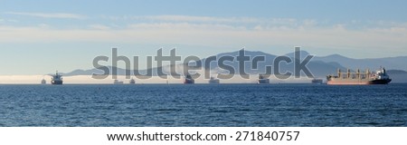 Outer harbor of Vancouver with the Vancouver Island, foggy mountains and Strait Georgia on background.