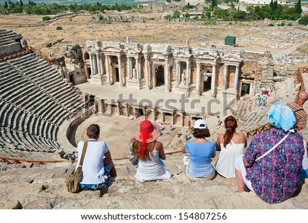 PAMUKKALE, TURKEY - JUNE 13: Unidentified tourists visit the ancient theater of the Roman city of Hierapolis on June 13, 2013 in Pamukkale, Turkey. The site is a UNESCO World Heritage site.