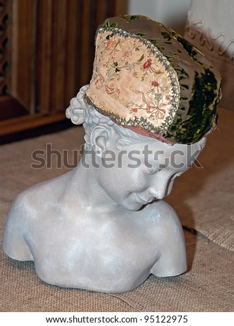 KIEV, UKRAINE - APRIL 16: A woman bust with fine cap is on display at the museum exhibit of Marina Ivanova\'s private collection of antique woman\'s clothes on April 16, 2011 in Kiev, Ukraine