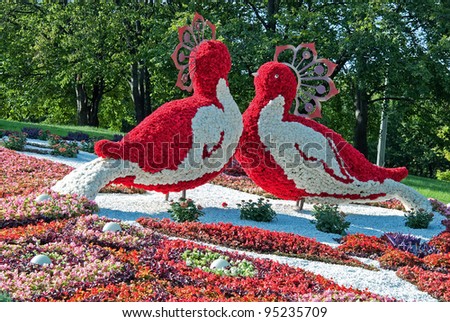 KIEV, UKRAINE - AUGUST 21: Two red fantastic birds close made of flowers at the 55th annual flower exhibition on August 21, 2010 in Kiev, Ukraine.