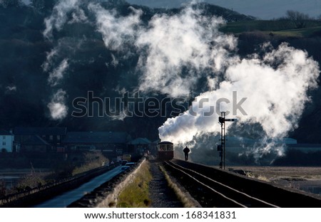 Ffestiniog & Welsh Highland steam train going over the Porthmadog Cob North Wales