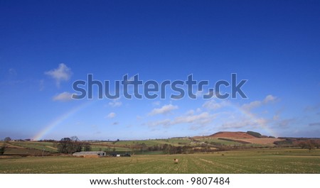 Rainbow over a Breamish Valley sheep farm in Northumberland England