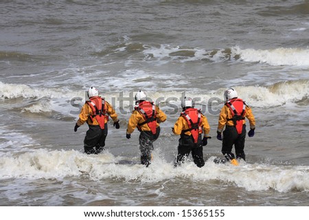 Four Lifeboat Crew walk out for a crew change on the inshore boat