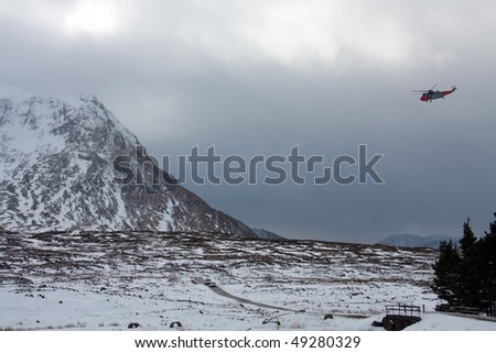 search and rescue helicopter Navy seaking flying around Glencoe in winter