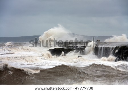 Holyhead breakwater and harbour in stormy weather with waves crashing over the walls Isle of Anglesey North wales