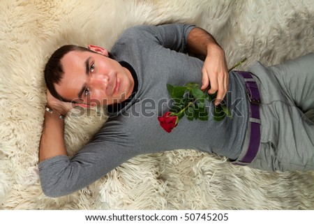 A sexy young man with rose, isolated