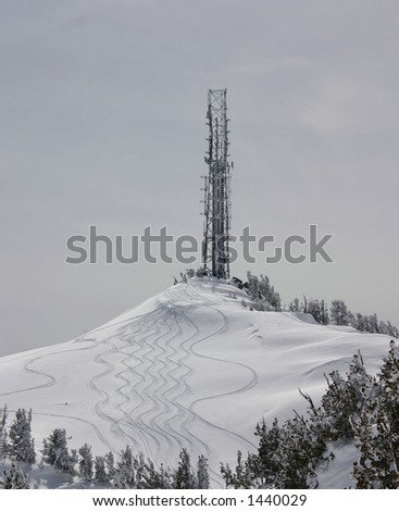 Communications tower on snow covered ski mountain
