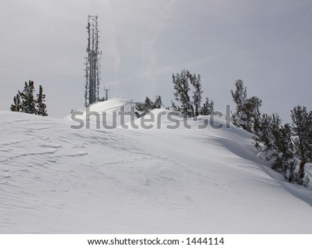 Communications tower on snow covered ski mountain