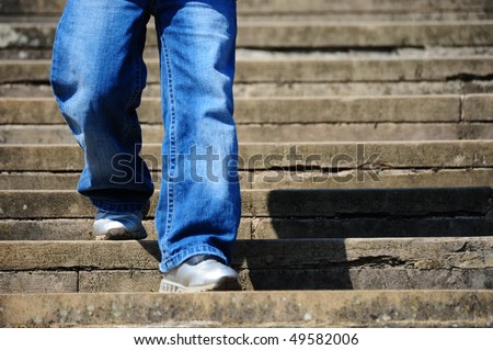small boy walking up some steps