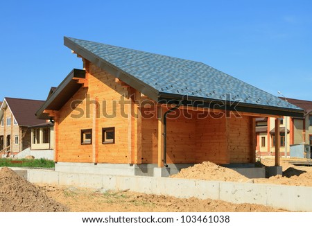 Wooden housing construction. A bath from a bar, a soft roof