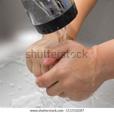 boy washes his hands