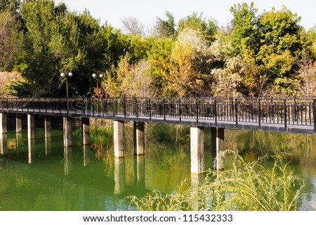 bridge over the lake in the arboretum. Shymkent