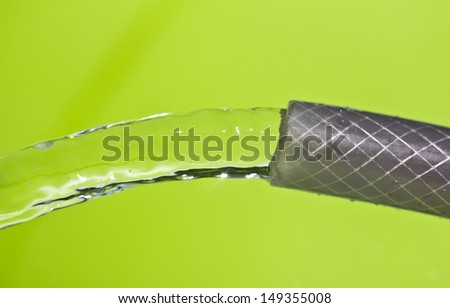 a jet of water from a hose on a green background