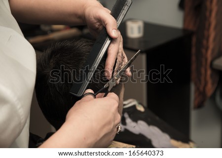 Men\'s haircut at the barber scissors