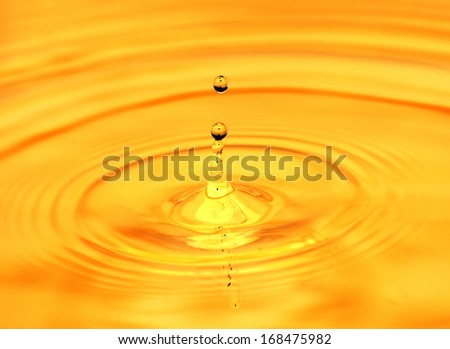 abstract background. A drop of water falls in gold
