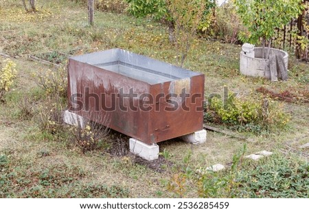 Similar – Image, Stock Photo Vintage water tank on high rusty iron frame in front of grey clouds