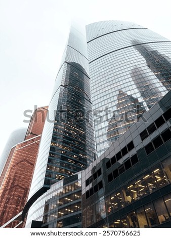 Similar – Image, Stock Photo Gloomy skyscraper facade with graphically cut hedge plant