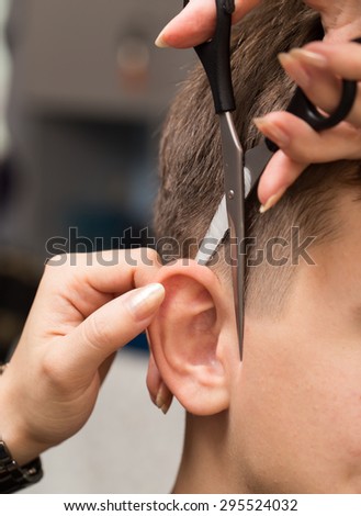 Haircut ear in a beauty salon