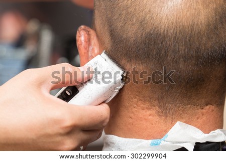 Close up of a male student having a haircut with hair clippers