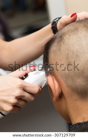 Man having a haircut with a hair clippers