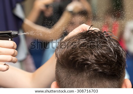 Rear view of man getting a haircut in beauty salon