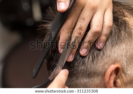 men\'s hair cutting scissors in a beauty salon