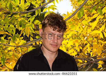 man in a black shirt on the background of autumn