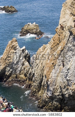 Cliff diving in Acapulco, Mexico with diver in air