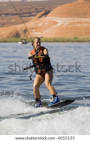 Girl wakeboarding at Lake Powell in Glen Canyon National Recreation Area Utah