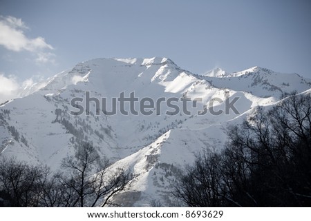 A snow-covered mountain peak in the mountains of Utah during the winter