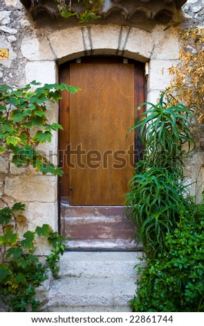 Old wooden door in the medieval city of Exe, France, which is a fortress, built on cliff-side hill
