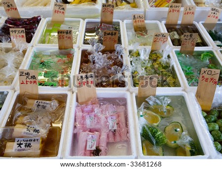 Various fresh seafood items for sale in an open market in Tokyo, Japan.