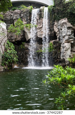 Waterfall cascading over rocks in a beautiful Hong Kong park