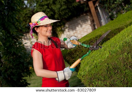 Gardener woman with hedge trimmers