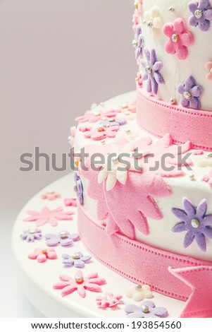 Details of a birthday cake, decorative stars in pink made of sugar.