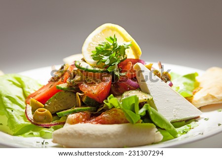 Salad with cheese, easy breakfast meal served on white plate.