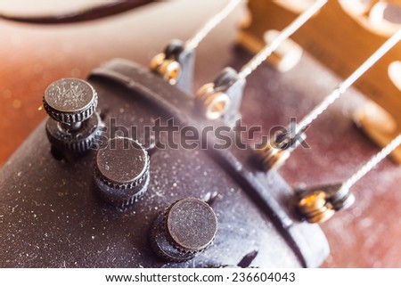 Micro tuners on violin for precise tuning, macro view.