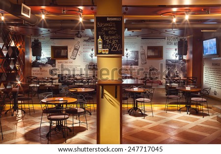 Cacak, Serbia - January 23, 2015: Velvet Cafe and Club interior, modern design with vintage chairs and tables and illustrative wallpapers.