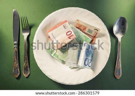 Conceptual composition, white plate full of euro money.